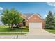 Charming brick home with a two-car garage and well-manicured lawn, enhancing curb appeal at 542 Hadleigh Ct, Westfield, IN 46074