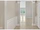 Neutral hallway with white trim leading to sunlit room with windows at 542 Hadleigh Ct, Westfield, IN 46074