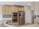 Kitchen featuring stainless appliances, wooden cabinets, mosaic backsplash, and a light wood floor at 542 Hadleigh Ct, Westfield, IN 46074