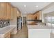 Kitchen featuring stainless steel appliances, light wood cabinets, mosaic backsplash, and light wood floors at 542 Hadleigh Ct, Westfield, IN 46074