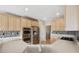 Kitchen with stainless steel appliances, light wood cabinets, and mosaic backsplash at 542 Hadleigh Ct, Westfield, IN 46074