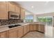 Modern kitchen featuring stainless appliances, wood cabinets, mosaic backsplash, and gas stove at 542 Hadleigh Ct, Westfield, IN 46074