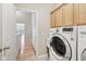 Functional laundry room with newer washer, dryer, sink, and cabinets for storage at 542 Hadleigh Ct, Westfield, IN 46074