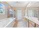 Main bath featuring a double vanity, soaking tub, glass enclosed shower and a window at 542 Hadleigh Ct, Westfield, IN 46074