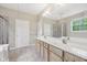 Main bath featuring a double vanity, soaking tub, glass enclosed shower and a window at 542 Hadleigh Ct, Westfield, IN 46074