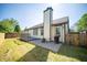 Home exterior featuring a backyard, a concrete patio, and mature trees at 5622 Mead Ct, Indianapolis, IN 46220