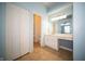 View of a bright bathroom with a full vanity, closet, and a combined shower and tub at 5622 Mead Ct, Indianapolis, IN 46220