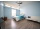 This bedroom features blue walls, a ceiling fan, and a large window for plenty of natural light at 5622 Mead Ct, Indianapolis, IN 46220
