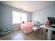 Cozy bedroom with lots of light from a large window and wood-look flooring at 5622 Mead Ct, Indianapolis, IN 46220