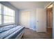 Bedroom with a bed, closet, window, and a door. Light and airy at 5622 Mead Ct, Indianapolis, IN 46220