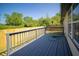 A gray painted outdoor deck with wood railings and a fenced in yard at 5622 Mead Ct, Indianapolis, IN 46220