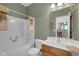 Bathroom features white shower and vanity with wood cabinets and green accent walls at 575 Dylan Dr, Avon, IN 46123