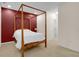 Bright bedroom showcasing a four-poster bed with white bedding, and neutral carpet at 575 Dylan Dr, Avon, IN 46123