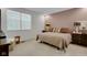 Comfortable bedroom featuring neutral carpet, ample natural light, and a mauve accent wall at 575 Dylan Dr, Avon, IN 46123