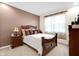 Bedroom with a bold accent wall features ample natural light, and an elegant wood-trimmed bed at 575 Dylan Dr, Avon, IN 46123