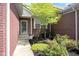Inviting home entrance featuring landscaped garden with flowering plants and a screen door at 575 Dylan Dr, Avon, IN 46123
