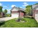 Charming brick home with a well-manicured lawn, lush landscaping, and attached two-car garage at 575 Dylan Dr, Avon, IN 46123