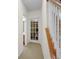 Hallway leading to basement, featuring carpeted steps, glass paneled door and painted trim at 575 Dylan Dr, Avon, IN 46123