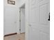 Hallway with three white doors and tile floor, offering access to various rooms at 575 Dylan Dr, Avon, IN 46123
