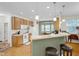 Cozy kitchen featuring wood cabinets, white appliances, and bar seating area for casual dining at 575 Dylan Dr, Avon, IN 46123