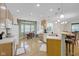 Well-lit kitchen with white appliances, oak cabinets, and a breakfast bar that overlooks the dining area at 575 Dylan Dr, Avon, IN 46123