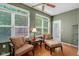 Relaxing sunroom features neutral furniture, many windows, and a ceiling fan for optimal comfort at 575 Dylan Dr, Avon, IN 46123