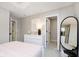 Bright bedroom featuring a dresser, a stylish mirror, and an open door to a spacious walk-in closet at 583 Dalton Way, Avon, IN 46123