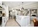 Bright kitchen features white cabinets, stainless steel appliances, pendant lighting, and an island with a sink at 583 Dalton Way, Avon, IN 46123