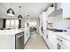 Open kitchen design featuring stainless steel appliances, a center island, and sleek white cabinets at 583 Dalton Way, Avon, IN 46123