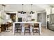 Modern kitchen with white cabinets, stainless steel appliances, large island with bar stools, and pendant lighting at 583 Dalton Way, Avon, IN 46123