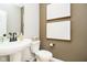 Stylish powder room features pedestal sink, modern fixtures, framed art, and neutral paint at 583 Dalton Way, Avon, IN 46123
