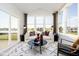 Cozy sunroom with large windows offering scenic lake views and comfortable seating at 583 Dalton Way, Avon, IN 46123
