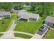 Aerial view of a home with a well-manicured lawn, spacious driveway, and lush landscaping at 633 Park Dr, Greenwood, IN 46143