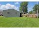 Fenced backyard with a well-maintained lawn and detached garage, offering privacy and space at 633 Park Dr, Greenwood, IN 46143