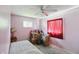 This bedroom has pink walls, white trim, and a ceiling fan at 633 Park Dr, Greenwood, IN 46143