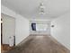 Carpeted Gathering room featuring a ceiling fan and a covered window at 633 Park Dr, Greenwood, IN 46143
