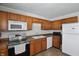 Kitchen showcasing wooden cabinets, stainless steel appliances, and tile floors at 633 Park Dr, Greenwood, IN 46143