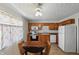 Kitchen with wooden cabinets, stainless appliances, and a cozy dining area at 633 Park Dr, Greenwood, IN 46143