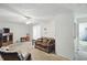 Bright living room showcasing a plaid sofa, television, and adjacent doorway at 633 Park Dr, Greenwood, IN 46143