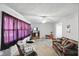 Cozy living room featuring a plaid sofa, armchair, and entertainment center at 633 Park Dr, Greenwood, IN 46143