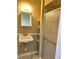 Cozy bathroom featuring a pedestal sink, a mirrored cabinet, and a shower stall with a sliding door at 660 N 700 E, Whitestown, IN 46075