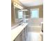 Bright bathroom with a white vanity, white tiled walls, and a window for natural light at 660 N 700 E, Whitestown, IN 46075