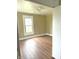 Cozy bedroom featuring laminate floors, neutral walls, and a window for natural light at 660 N 700 E, Whitestown, IN 46075