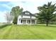 Inviting two-story home with a covered front porch and a lush green lawn at 660 N 700 E, Whitestown, IN 46075