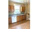 Functional kitchen featuring wood cabinets, a double basin sink, and a white dishwasher at 660 N 700 E, Whitestown, IN 46075