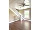 Bright living room with laminate floors, a staircase with carpeted steps, and a window at 660 N 700 E, Whitestown, IN 46075