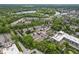 Aerial view of a neighborhood featuring lush greenery, local businesses and a nearby lake at 6665 Boxcar Pl, Indianapolis, IN 46220
