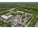 Aerial view of a neighborhood surrounded by lush greenery with a baseball field, a lake, and local businesses nearby at 6665 Boxcar Pl, Indianapolis, IN 46220