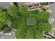 An aerial view of a community park featuring a charming fountain surrounded by lush greenery and walkways at 6665 Boxcar Pl, Indianapolis, IN 46220