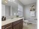 Well-lit bathroom with a white sink, cabinets, a large mirror and coordinated decor at 6665 Boxcar Pl, Indianapolis, IN 46220